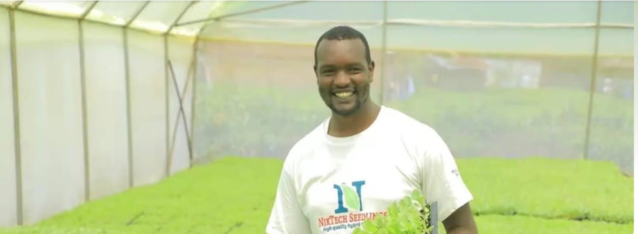 Nick Otiso of NikTech Seedlings inside a propagation greenhouse in Nyamira
